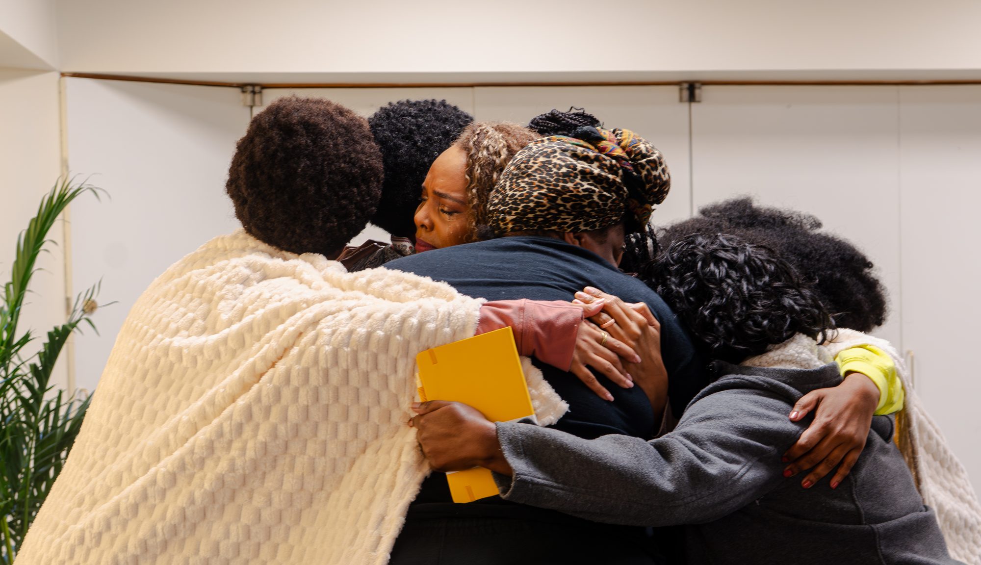 Women in a group embrace