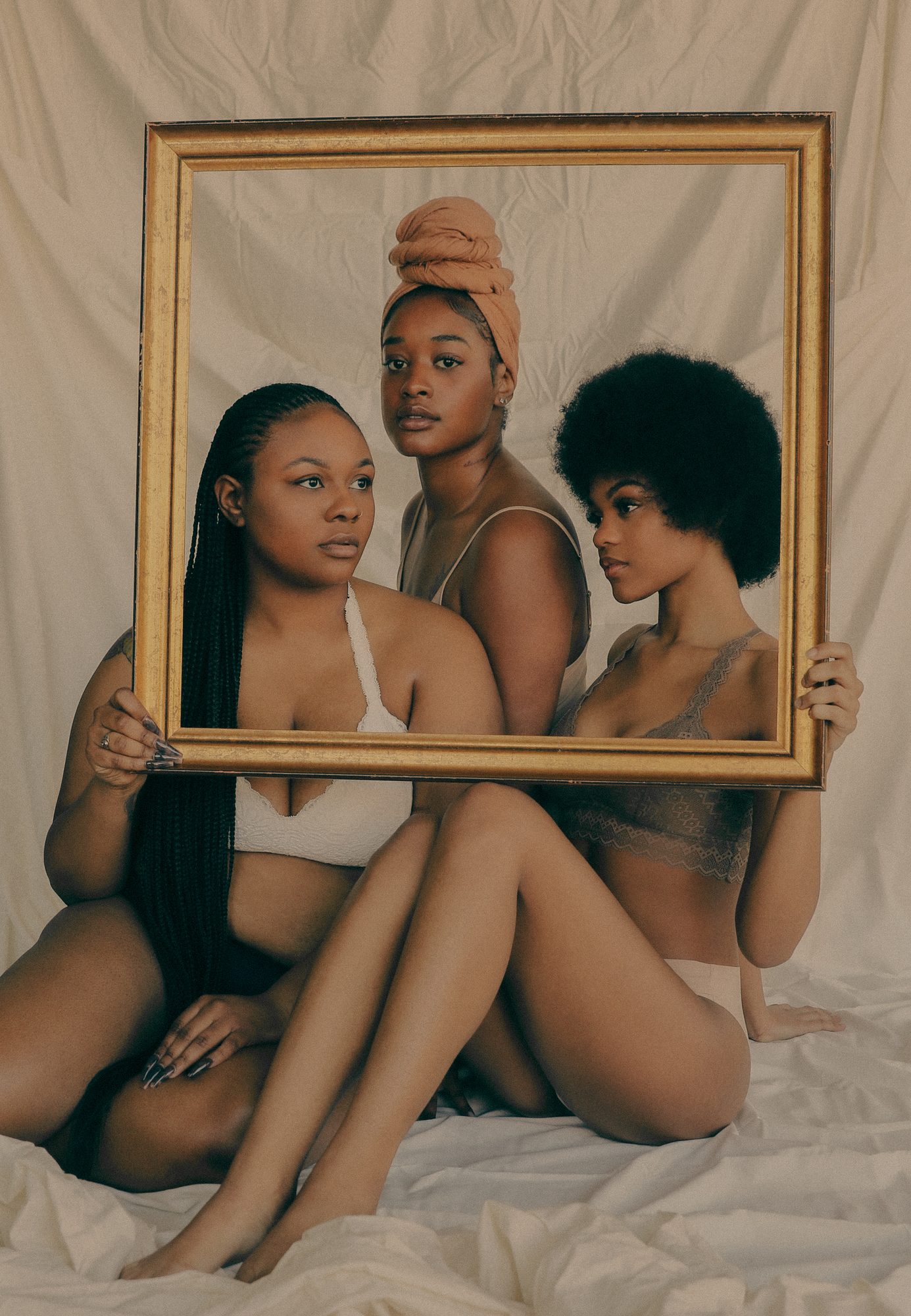 Three women framed in gold, CRXWNED campaign