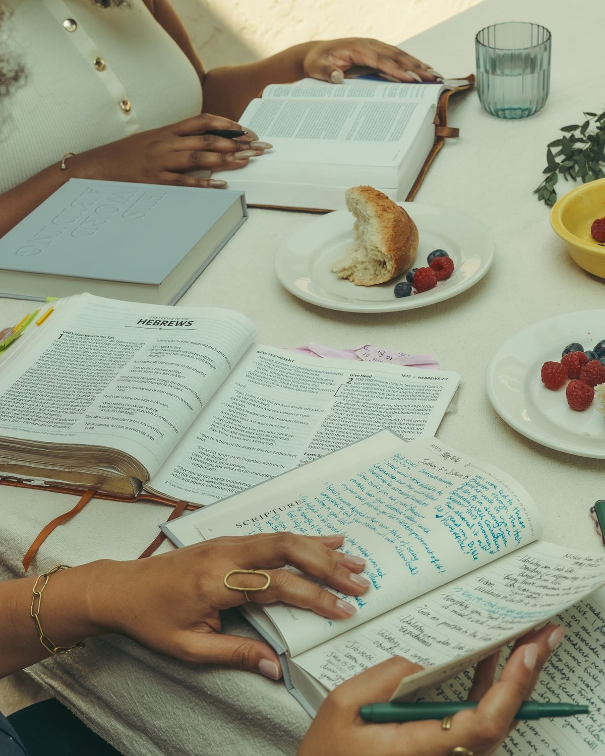 Open Bibles, the journal and bread on a shared table